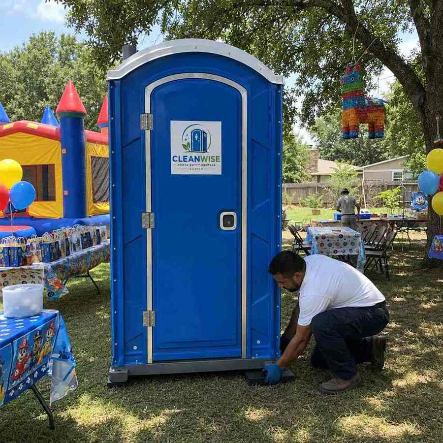 Cleanwise technician cleaning and servicing a porta potty rental in Austin